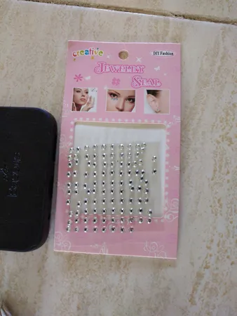 پیرسینگ بینی زنانه مدل چسبی طرح الماس کد nos110 بسته 100 عددی