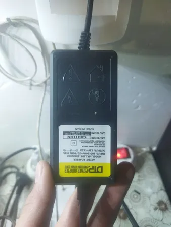 آداپتور 12 ولت 2 آمپر دی ای پی مدل dk1203_shenzhen