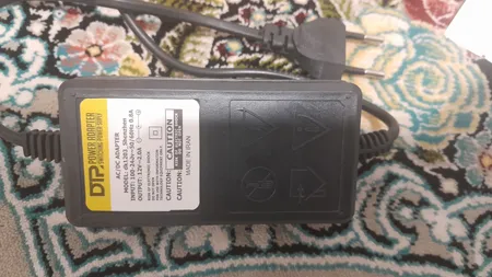 آداپتور 12 ولت 2 آمپر دی ای پی مدل dk1203_shenzhen