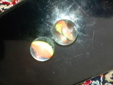 تیله شیشه ای گلدونه مدل سه پر چندرنگ بسته 100 عددی