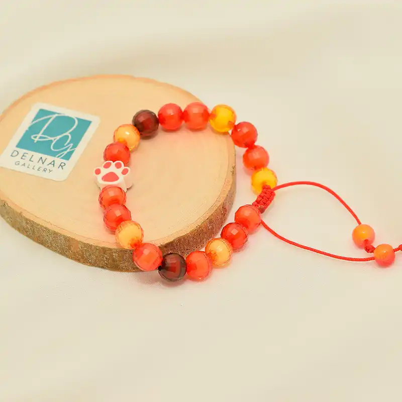 دستبند دخترانه دلنار گالری مدل پنجه پیشی و مهره آبنباتی