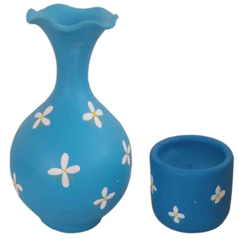 گلدان سفالی طرح گل به همراه شمعدان