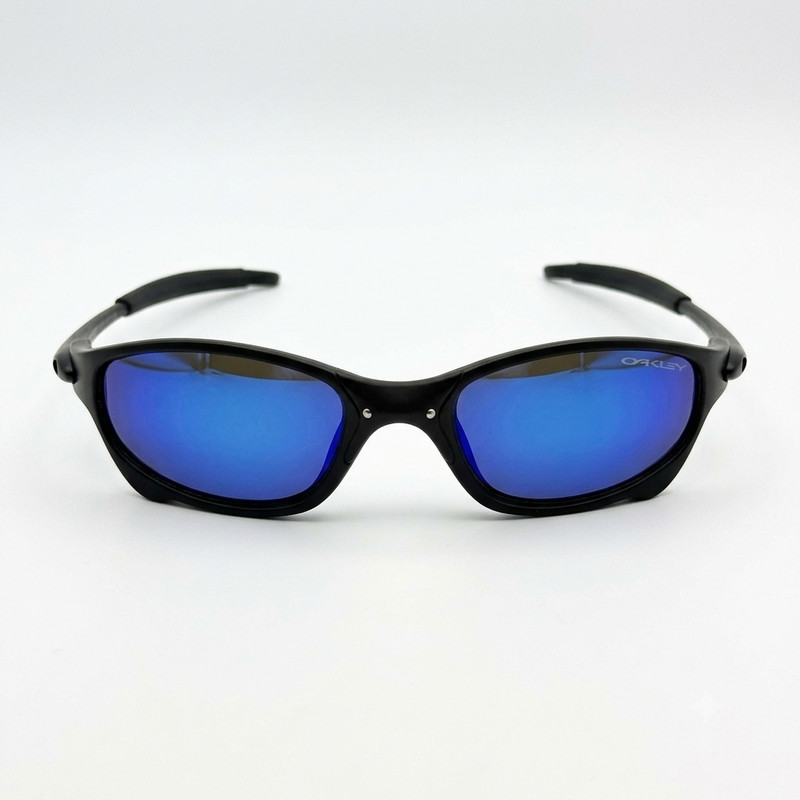 عینک ورزشی اوکلی مدل Julit170 با لنز پلی‌کربنات آبی آینه‌ای مناسب آب و هوای برفی، همراه با جعبه دستمال و کاور