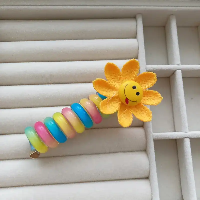 کش مو زنانه مدل فنری طرح گل آفتابگردان