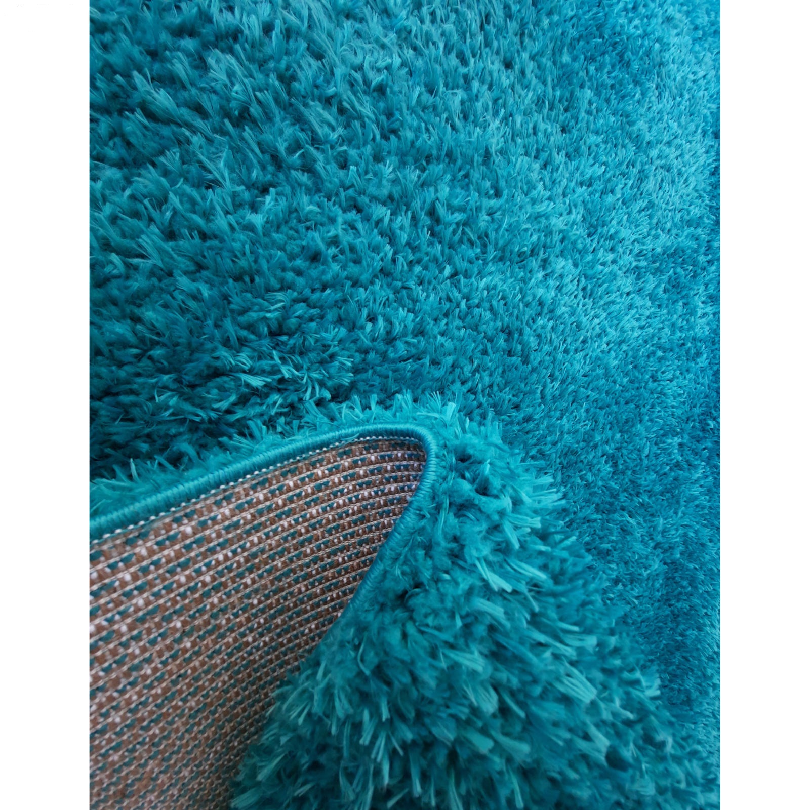 فرش ماشینی مدل شگی فلوکاتی زمینه آبی فیروزه ای