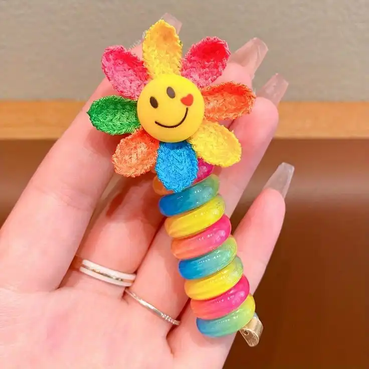 کش مو زنانه مدل فنری طرح گل آفتابگردون