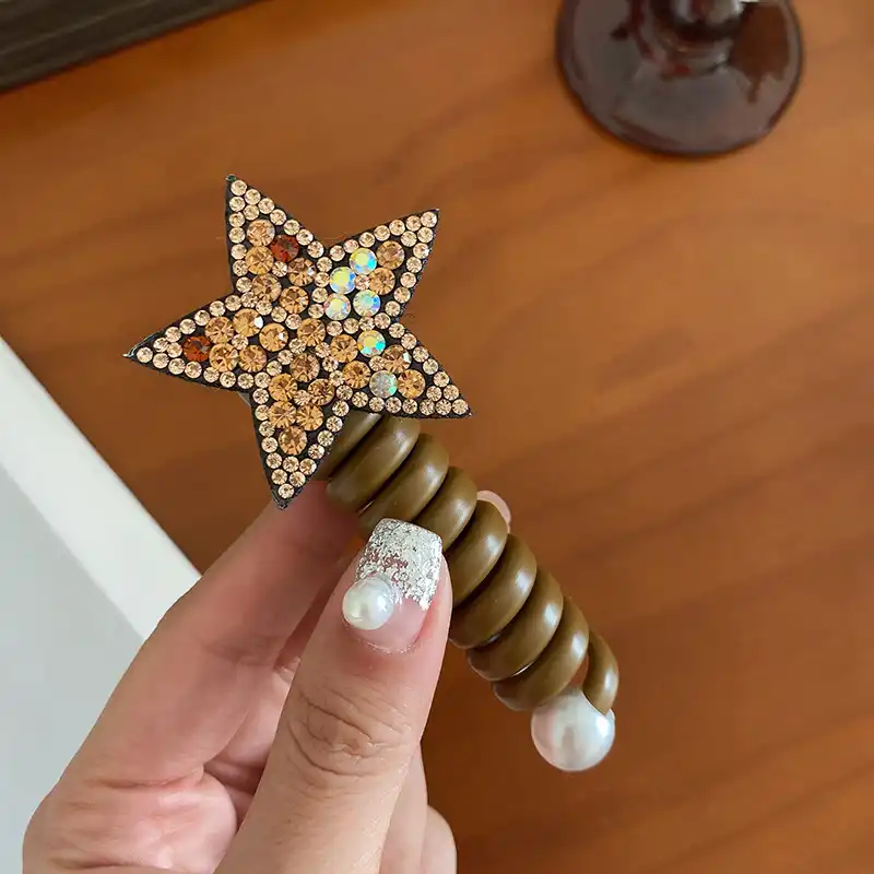 کش مو زنانه مدل فنری طرح ستاره نگینی