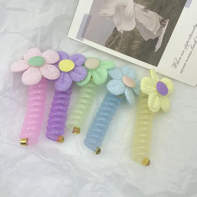 کش مو زنانه مدل فنری طرح گل بابونه