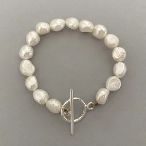 دستبند نقره زنانه الماسین آذر مدل مروارید و قفل تی