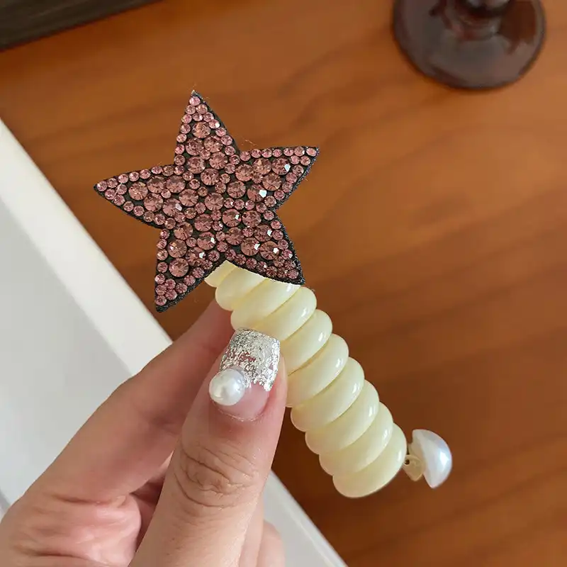 کش مو زنانه مدل فنری طرح ستاره نگینی