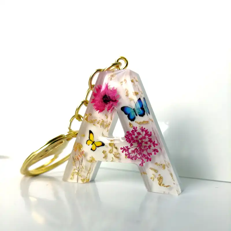 جاکلیدی رزینی طرح گل و پروانه مدل حرف A